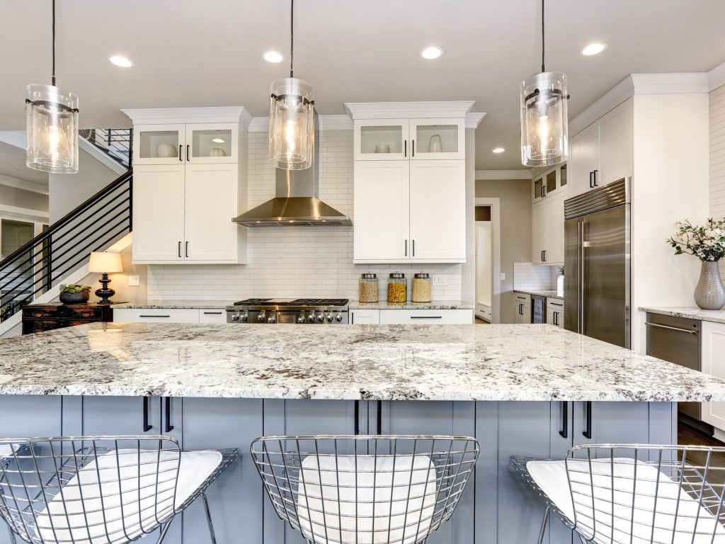 Beautiful kitchen in luxury modern home interior with island and stainless steel chairs