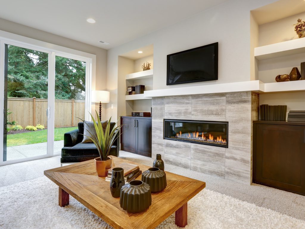 Beautiful modern living room interior with stone wall and fireplace in luxury home